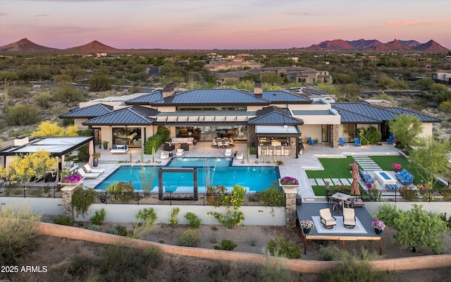 8328 E Whisper Rock Trl, Scottsdale, AZ 85266 - pool at dusk with a community pool, a gazebo, a mountain view, an outdoor living space, and fence private yard