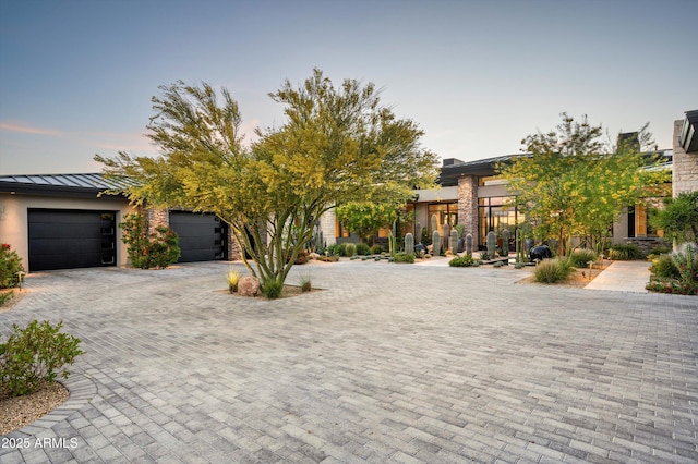 8328 E Whisper Rock Trl, Scottsdale, AZ 85266 - view of front of home featuring a standing seam roof, driveway, a garage, and stucco siding