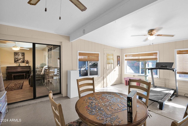 dining space with lofted ceiling with beams, ceiling fan, and a healthy amount of sunlight