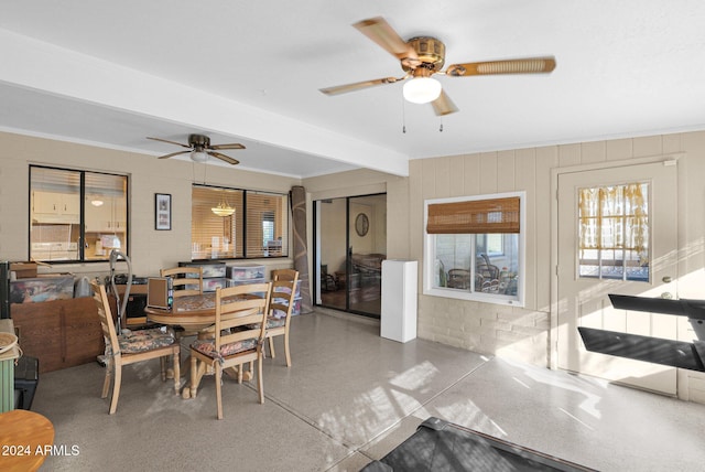 dining area featuring beamed ceiling, ceiling fan, and crown molding