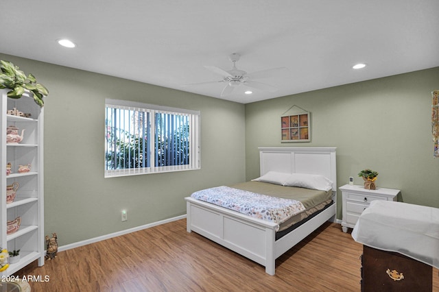 bedroom with ceiling fan and light hardwood / wood-style floors