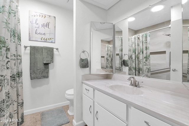 bathroom with tile patterned floors, vanity, and toilet