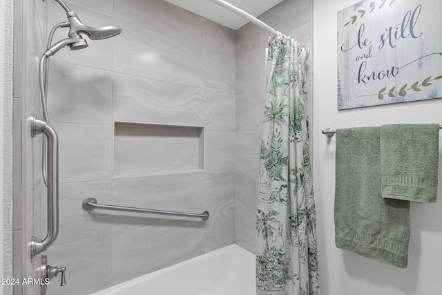 bathroom with shower / bath combo with shower curtain