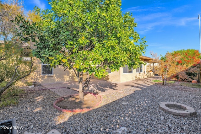 view of yard with a patio and a fire pit