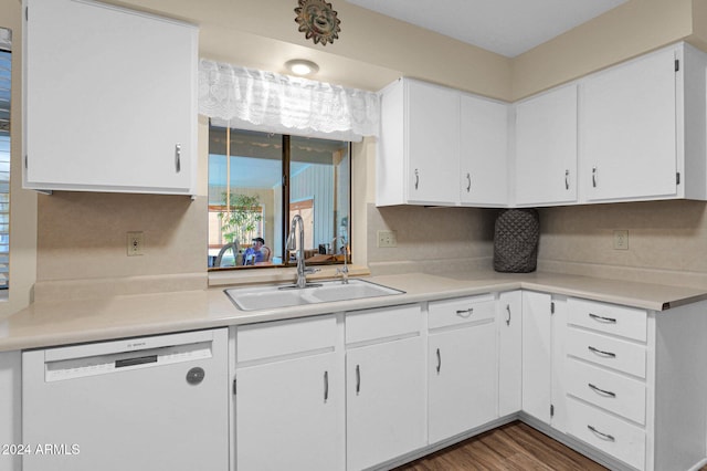 kitchen with dishwasher, dark hardwood / wood-style floors, white cabinetry, and sink