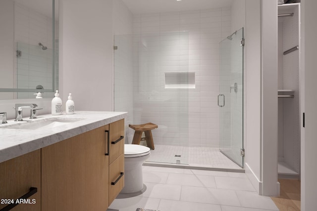 bathroom featuring vanity, toilet, an enclosed shower, and tile patterned flooring