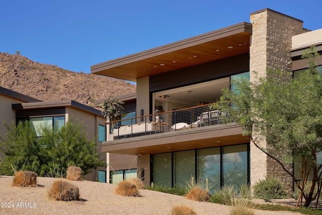 rear view of property with a balcony