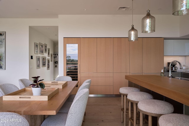 dining room with sink and wood-type flooring