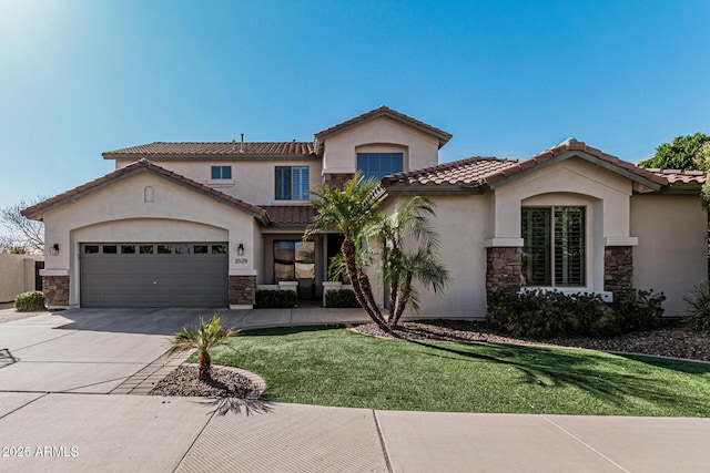 mediterranean / spanish home featuring a front lawn and a garage