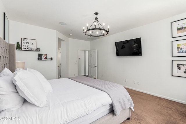 bedroom with a notable chandelier and carpet floors