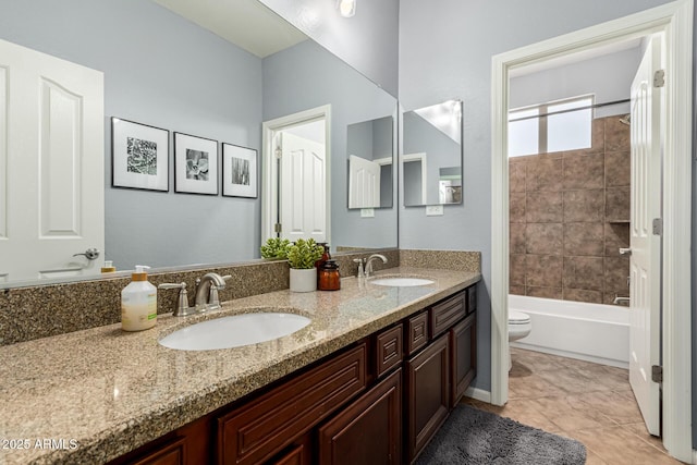 full bathroom with toilet, vanity, and tiled shower / bath