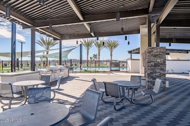 1205 W Sparrow Dr, Queen Creek, AZ 85140 - view of patio featuring fence, a community pool, outdoor dining area, and area for grilling