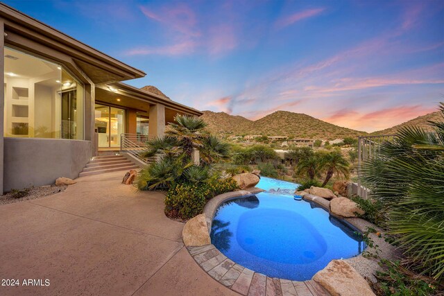 view of front of property featuring a garage and a mountain view