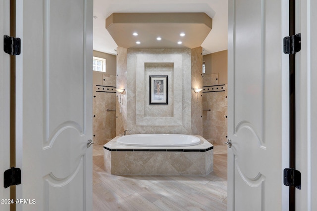 bathroom with tiled tub