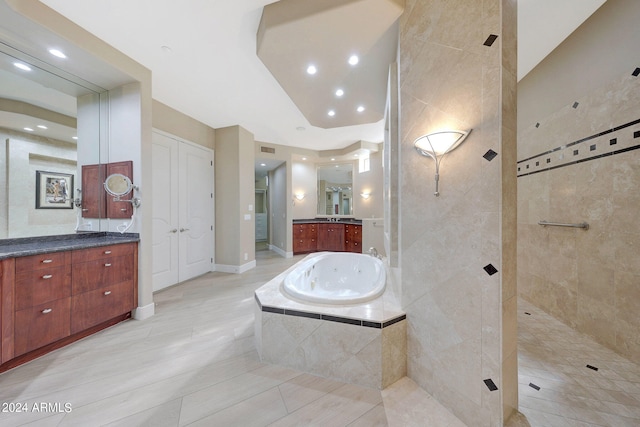 bathroom featuring vanity and separate shower and tub