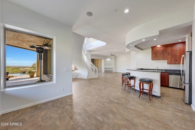 kitchen with appliances with stainless steel finishes and a kitchen breakfast bar