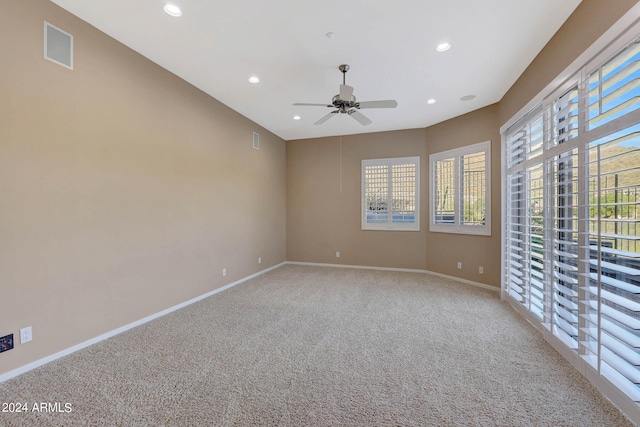 unfurnished room featuring carpet floors and ceiling fan