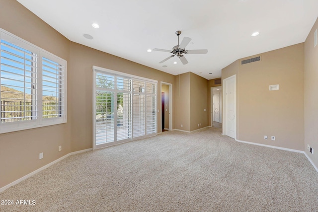 spare room featuring ceiling fan and carpet floors