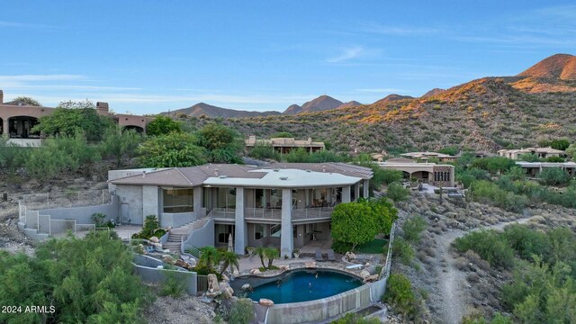 patio terrace at dusk with area for grilling, grilling area, and a mountain view