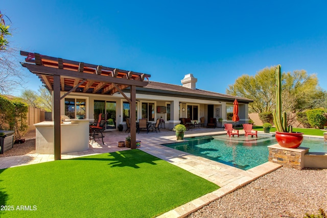 back of house with a chimney, a fenced in pool, outdoor dry bar, a patio, and a hot tub
