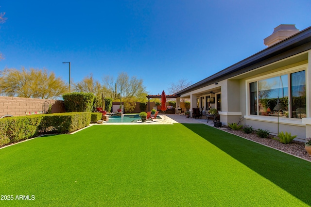 view of yard featuring a fenced backyard, a ceiling fan, a patio, and a fenced in pool