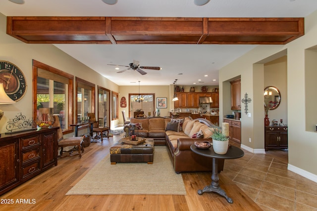 living room featuring recessed lighting, beam ceiling, baseboards, and ceiling fan with notable chandelier