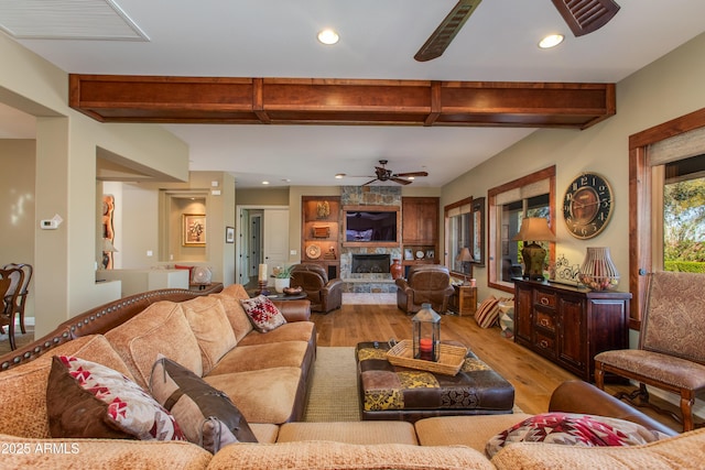 living room featuring ceiling fan, light wood-style floors, beamed ceiling, and recessed lighting