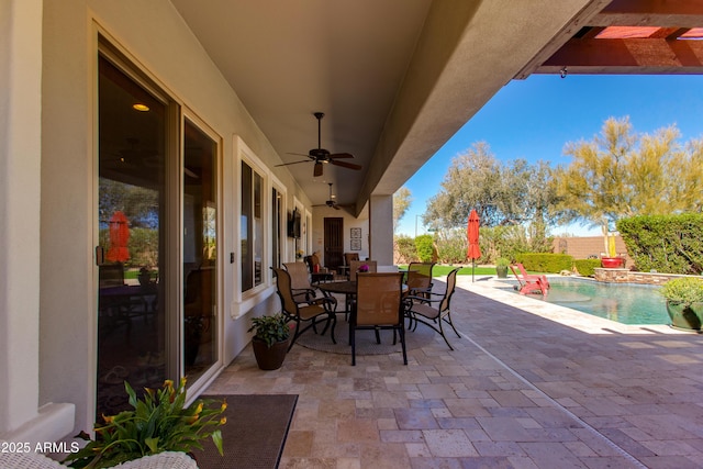 view of patio / terrace with outdoor dining space, a fenced in pool, and a ceiling fan