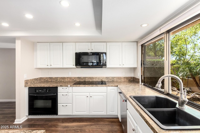 kitchen with recessed lighting, dark wood finished floors, a sink, and black appliances