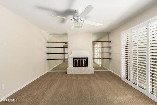 unfurnished living room featuring baseboards, carpet flooring, ceiling fan, and a fireplace