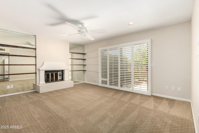unfurnished living room featuring carpet flooring, ceiling fan, a brick fireplace, recessed lighting, and baseboards