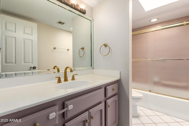 bathroom with visible vents, tile patterned flooring, vanity, toilet, and bath / shower combo with glass door