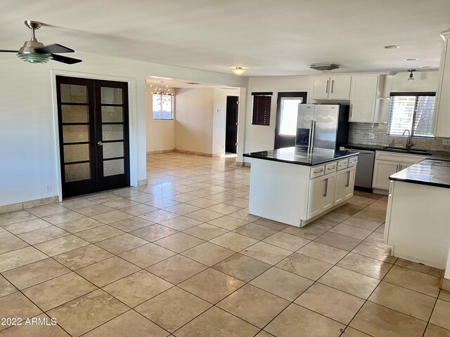 4213 N Westview Dr, Phoenix, AZ 85015 - kitchen featuring stainless steel appliances, a sink, dark countertops, and healthy amount of natural light