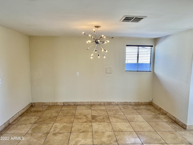 4213 N Westview Dr, Phoenix, AZ 85015 - empty room featuring a chandelier, light tile patterned floors, and baseboards