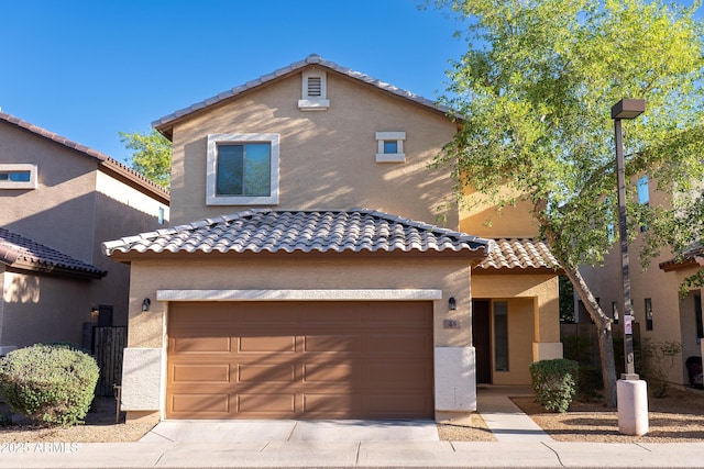 10225 W Camelback Rd Unit 45, Phoenix, AZ 85037 - mediterranean / spanish house featuring a tiled roof, stucco siding, a garage, and concrete driveway