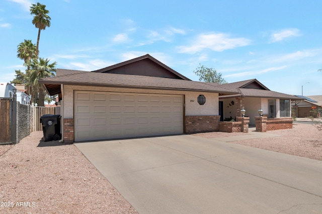 single story home featuring a garage, concrete driveway, brick siding, and fence