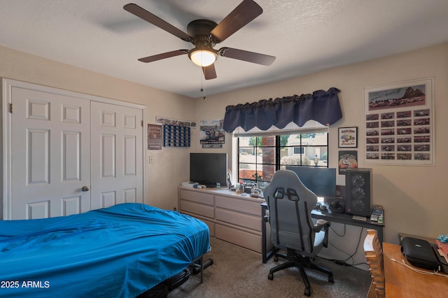 bedroom with carpet floors, an office area, a closet, and a ceiling fan