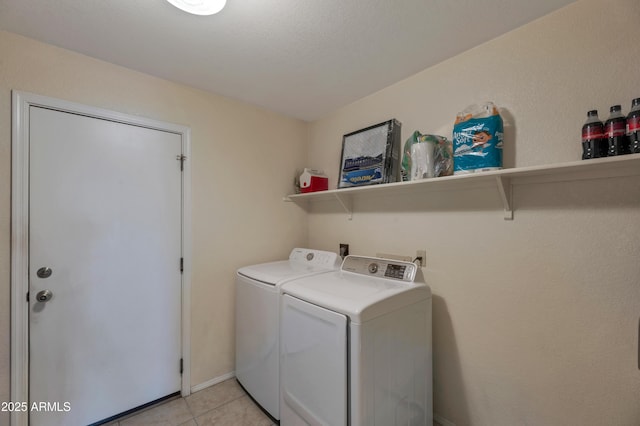 washroom with independent washer and dryer and light tile patterned floors