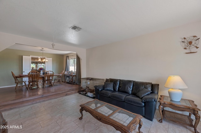 living area featuring a chandelier