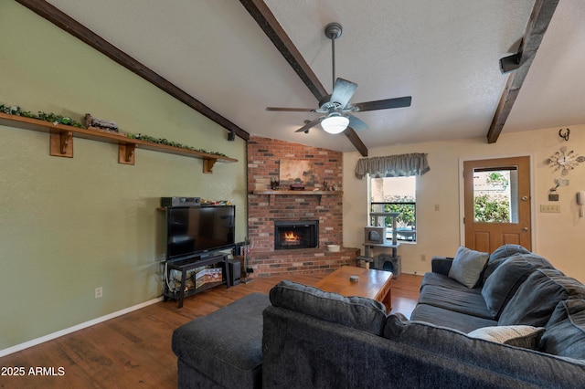 living area featuring wood finished floors, ceiling fan, a brick fireplace, and baseboards