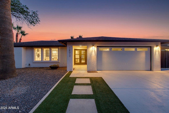 14012 N 57th Pl, Scottsdale, AZ 85254 - ranch-style home featuring a garage, driveway, and stucco siding