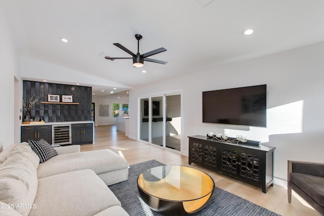 14012 N 57th Pl, Scottsdale, AZ 85254 - living area featuring beverage cooler, light wood finished floors, ceiling fan, recessed lighting, and a bar
