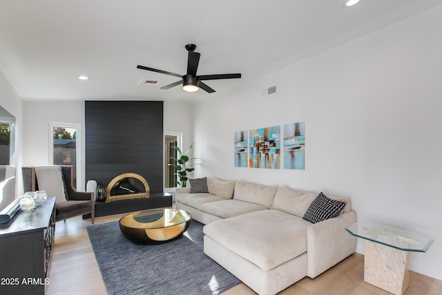 14012 N 57th Pl, Scottsdale, AZ 85254 - living area with recessed lighting, light wood-style floors, a ceiling fan, vaulted ceiling, and a large fireplace