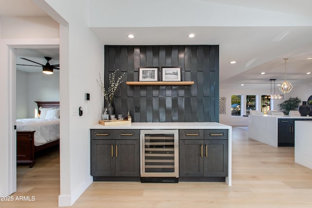 14012 N 57th Pl, Scottsdale, AZ 85254 - indoor dry bar with beverage cooler, light wood-type flooring, recessed lighting, decorative light fixtures, and ceiling fan