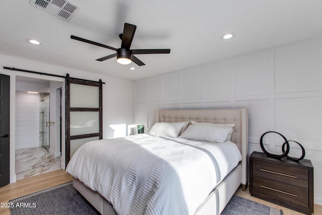 14012 N 57th Pl, Scottsdale, AZ 85254 - bedroom featuring a decorative wall, a barn door, recessed lighting, and a ceiling fan