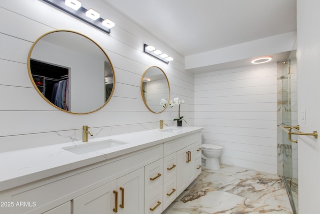 14012 N 57th Pl, Scottsdale, AZ 85254 - full bathroom featuring marble finish floors, double vanity, a stall shower, and a spacious closet