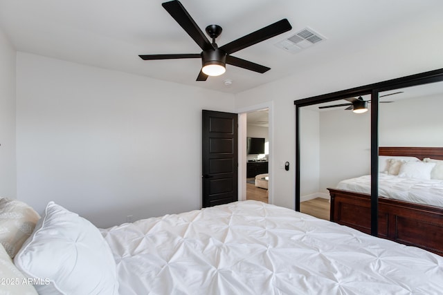 14012 N 57th Pl, Scottsdale, AZ 85254 - bedroom featuring a ceiling fan, wood finished floors, and a closet