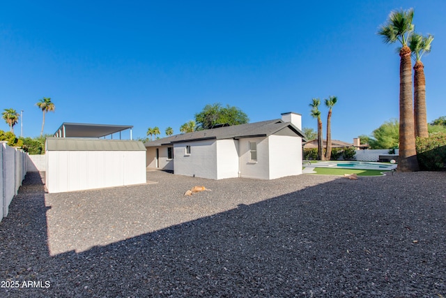 14012 N 57th Pl, Scottsdale, AZ 85254 - back of house with a fenced backyard, a chimney, and a patio area