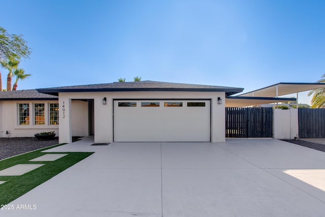 14012 N 57th Pl, Scottsdale, AZ 85254 - view of front facade featuring concrete driveway, a garage, and stucco siding