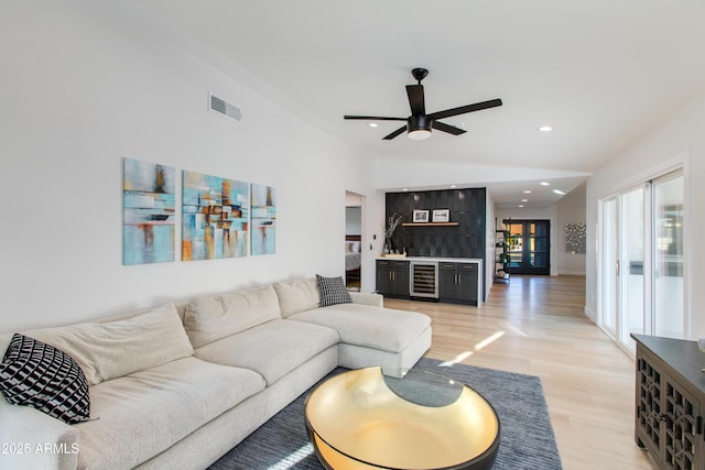 14012 N 57th Pl, Scottsdale, AZ 85254 - living area with beverage cooler, vaulted ceiling, ceiling fan, light wood finished floors, and recessed lighting